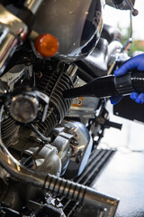 Fototapeta na wymiar Motorcycle. Car Wash. Motorcycle cleaning with foam injection. Make more clean.