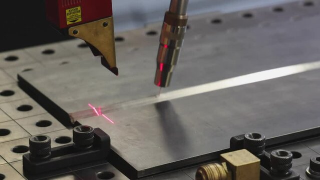 Automated Welding Robot Process With Red Laser Beam Navigation at Work Table