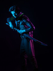 A guy in a cyberpunk image, holding a tuned katana in his hands. A young man in neon lighting on a black background