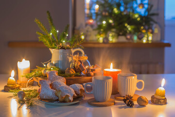 two cups of tea with homemade christmas baked goods on kitchen with christmas decoration