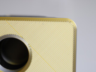Close up of a 3D printed object with a shiny golden top surface