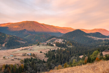 Amazing summer sunrise in Carpathian mountains. Colorful morning scene with first sunlight glowing hills and valleys