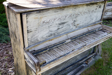 Dumped and damaged vintage upright piano with parts exposed stay outside