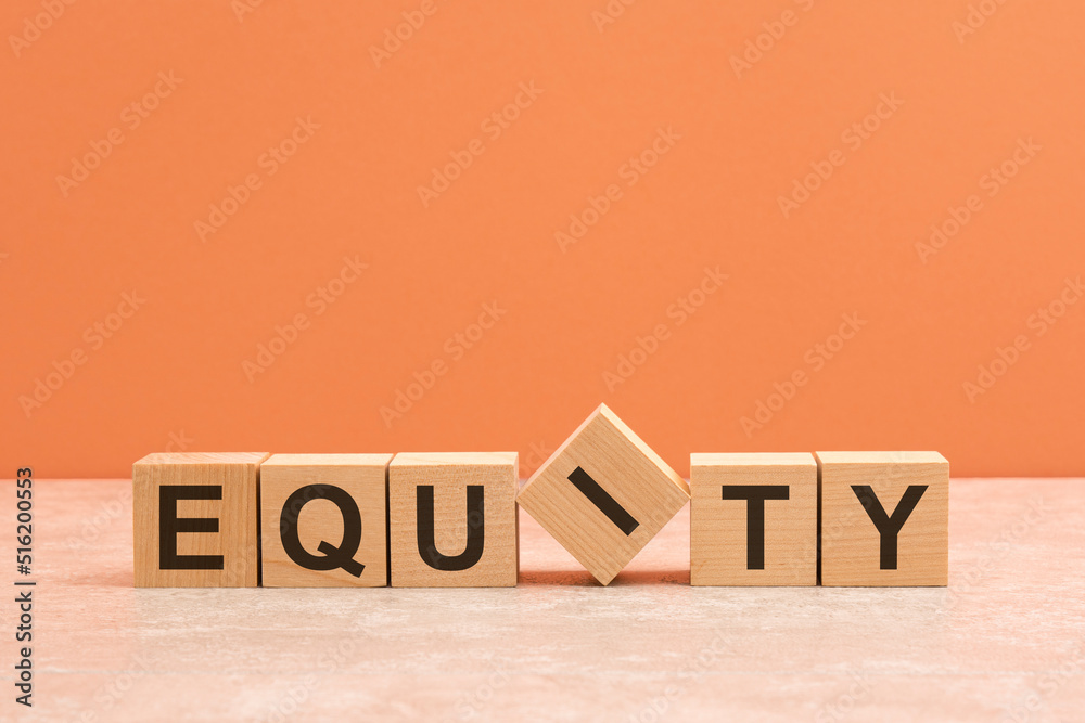 Wall mural equity text on a wooden blocks, orange background