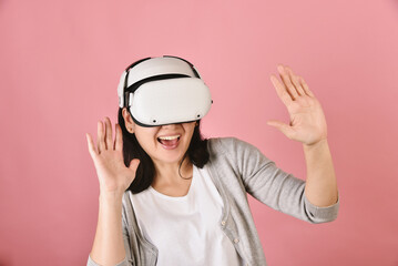 Asian woman using vr glasses, Watching movie and playing video games from virtual reality headset, Young woman amazing with new experience by vr technology, Studio shot.