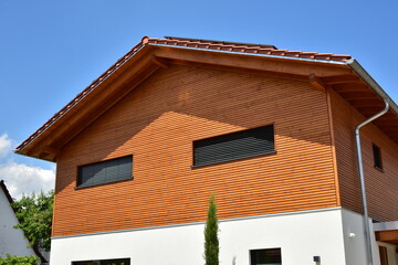 Mit Holzplanken verschaltes modernes Wohnhaus als Niedrigenergiehaus