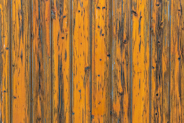 Yellow, vertically oriented planks with chipped yellow color.
