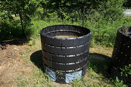 Waste container with organic biodegradable food waste and vegetable leftovers, garden compost pit for making compost. Composting at home concept