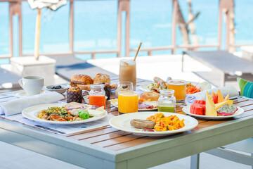 Breakfast in tropical hotel with sea view. Buffet food in restaurant in modern resort. Concept of travel and summer vacation.