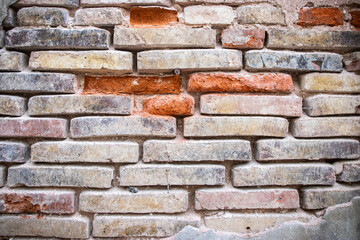 Broken old red masonry bricks wall. Background and texture concept.