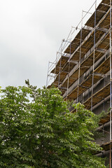 Scaffolding, renovation works being carried to building exterior. Overhaul of a 9-storey building
