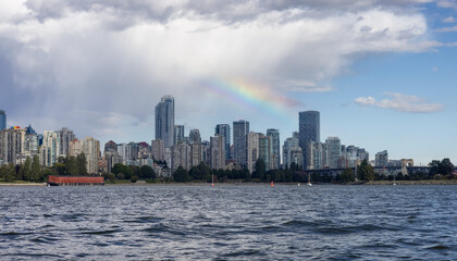 Fototapeta premium Downtown Vancouver City Skyline with clouds and rainbow. False Creek, British Columbia, Canada. Modern Cityscape on West Coast of Pacific Ocean.