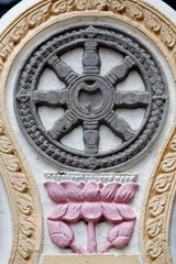 Buddhist symbols in Wat Ounalom : sculpture depicting the wheel and lotus flower