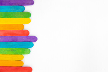 Top view of colorful ice cream sticks on white background