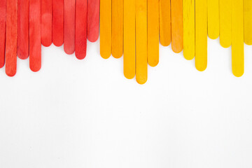 Top view of colorful ice cream sticks on white background