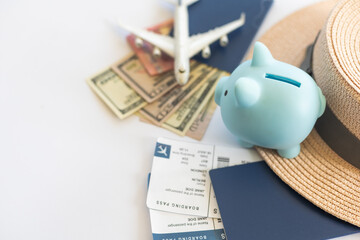 Save money for airplane tickets, planning travel budget concept. Airplane model, piggy bank on wooden table - Powered by Adobe