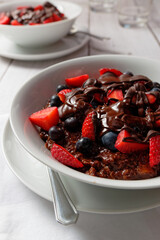 Chocolate banana oatmeal, with strawberries and blueberries. Covered with melted chocolate.