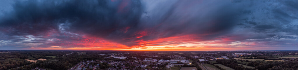 Fototapeta premium dramatic sunset panorama above a small german city