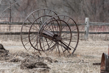 Fototapeta na wymiar Old rusty farm equipment in the farm land