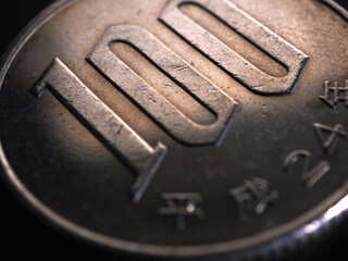 Translation: year of issue 2012. Japanese 100 yen coin closeup. Brown tinted illustration for news...