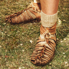 An ancient Roman man legs in caligae leather sandals. Reconstruction of the events of the Roman...