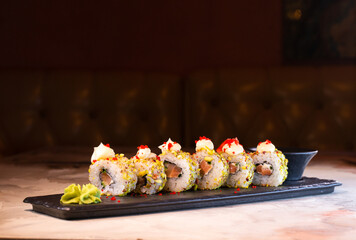 japanese dish rice rolls with cheese on a black plate