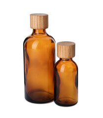New empty glass bottles with wooden caps isolated on white