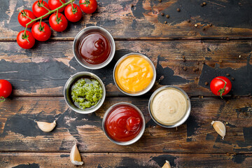 assorted sauces top view on old dark wooden table