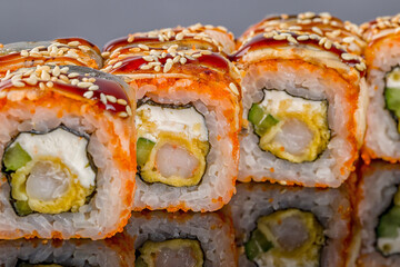 California roll with shrimp on black with reflection