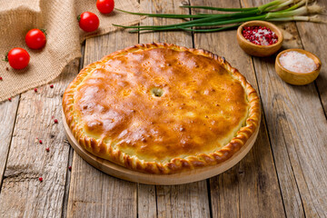 Ossetian pie with meat on wooden table