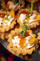 tartlet with cheese and caviar close-up. appetizer at the buffet
