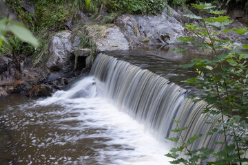 View of waterfall in summer nature, waterfall in Czech forest

