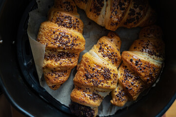 Homemade chocolate croissants with chocolate sprinkles baked in air fryer at home