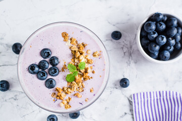 Smoothie bowl with blueberries and granola. Organic antioxidant diet food. Top view. Close-up