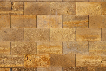 A wall of beige, ochre-colored bricks. Background. Copy Space