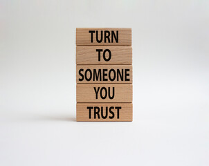 Turn to Someone you trust symbol. Wooden blocks with words Turn to Someone you trust. Beautiful white background. Business and Turn to Someone you trust. Copy space.