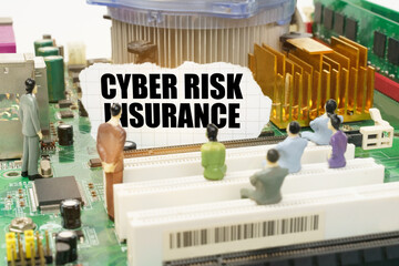 On the motherboard there are figures of people and torn paper with the inscription - Cyber Risk...