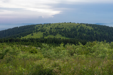 Obraz premium Mravenecnik hill , view from upper water reservoir of the pumped storage hydro power plant Dlouhe Strane in Jeseniky Mountains, Czech Republic. Summer sunset evening. 