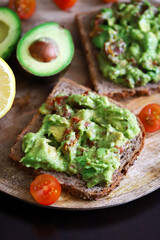 Guacamole sandwiches on a wooden board. Keto diet food.