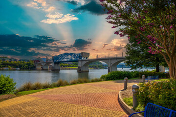 the majestic blue Chief John Ross Bridge over the Tennessee River surrounded by lush green trees...