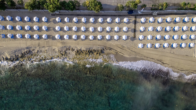 Beach umbrellas in front of Zorbas village Hotel, Anissaras, Crete