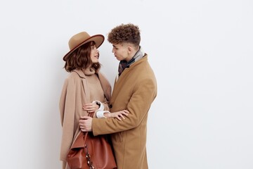 a happy couple is standing in autumn , stylish clothes and no need to hug each other looking at each other