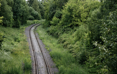Fototapeta na wymiar Rail tracks in the green field.