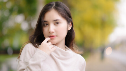 portrait cheerful smiling asian woman  with blooming golden shower flower
