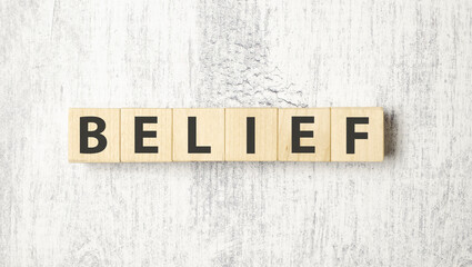 Word BELIEF made with wood building blocks