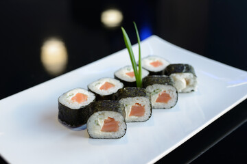 Sushi rolls on white dish. Japanese food.