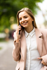 A portrait of a smiling beautiful woman talking on the phone