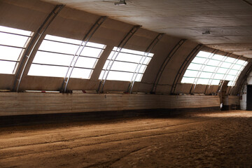 Background image of empty indoor riding arena at horse ranch in countryside, copy space