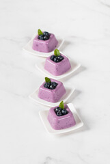 Mini Blueberry cream dessert, Panna Cotta in the form of square portions. Light background
