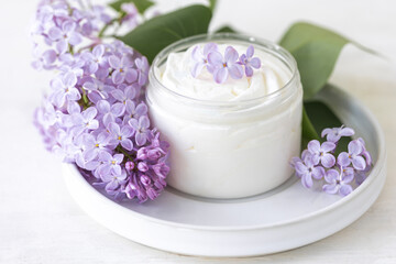 Concept of pure natural organic plant-based ingredients in cosmetology, herbal and flower extract. Lilac for anti-age and anti-acne therapy, gentle face and body skin care